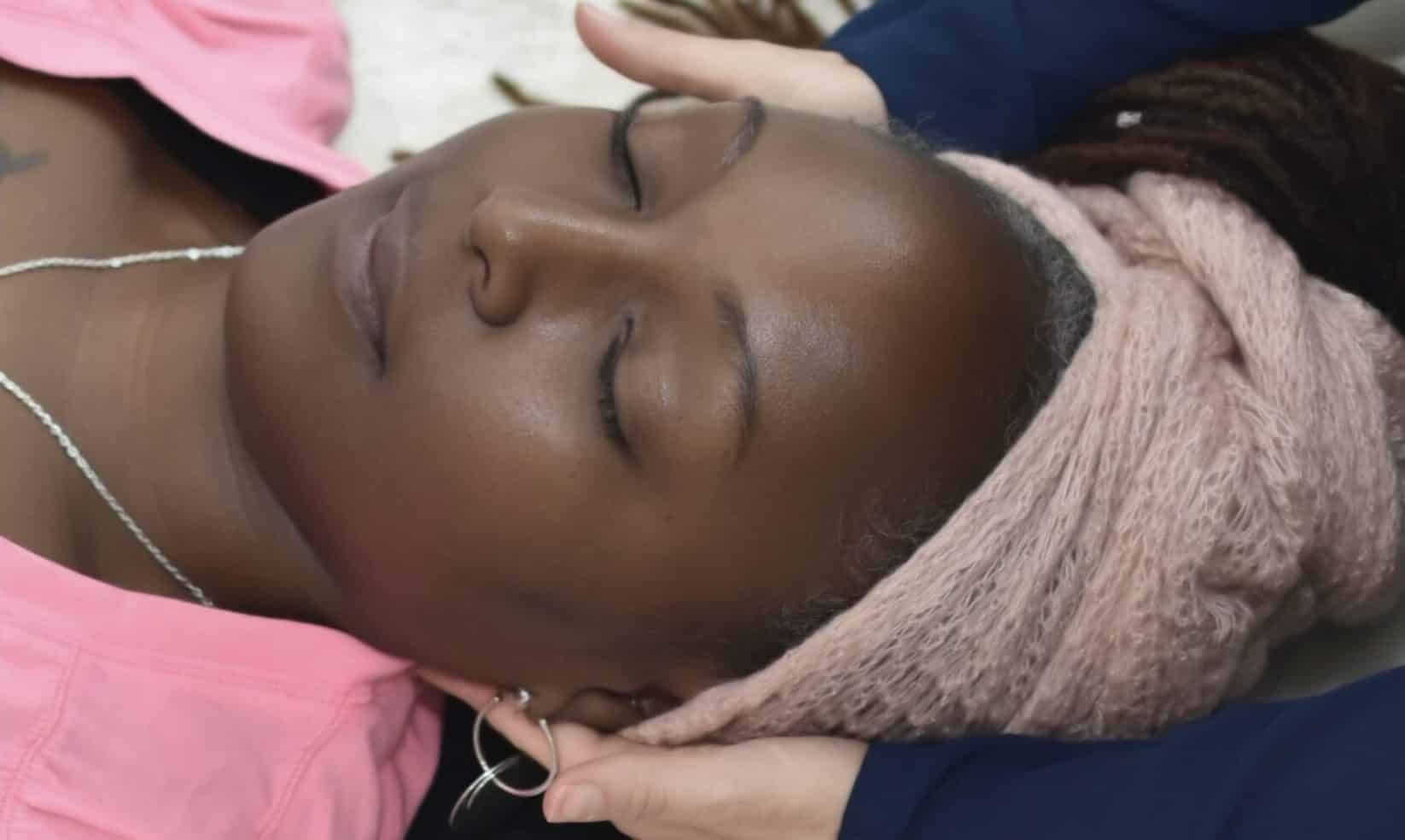 Hands on side of clients head in relaxation looking at ease