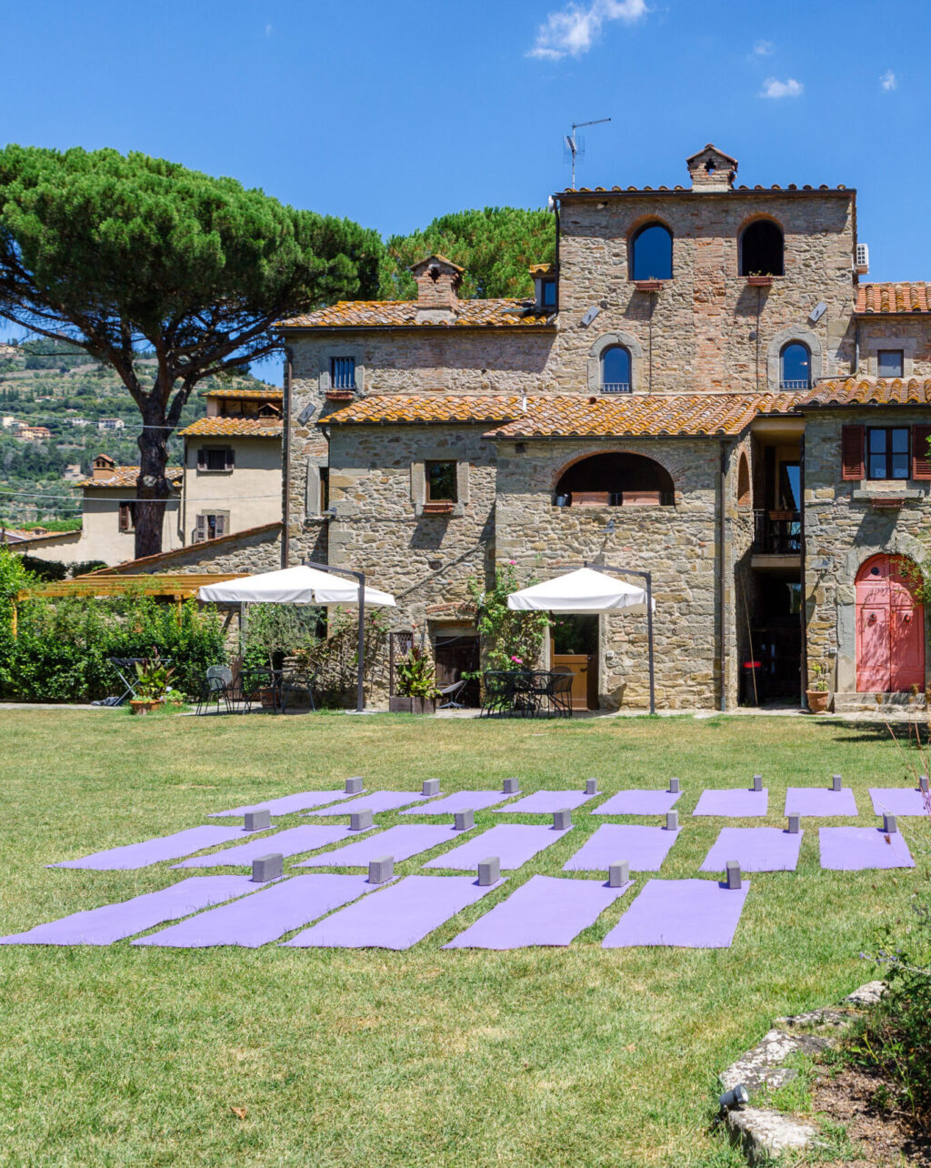 image of yoga mats on lawn in front of monastero